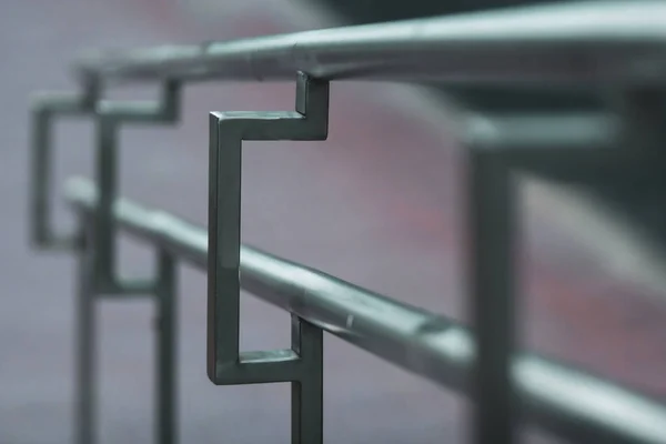 Stainless steel handrails on the street receding into the distance with selective focus. Beautiful for the background.