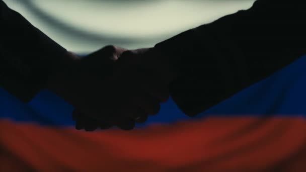 Handshake. Multiple takes. Russia flag on LED background. — Stock Video