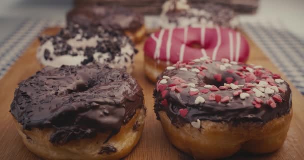 Female Hand Taking One Donut Plate Full Colorful Donuts — Stock Video