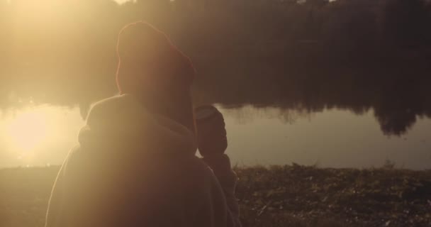 Young Female Cold Morning Sitting Lake Drinking Coffee — Stock Video