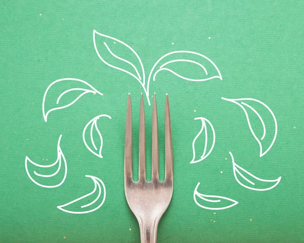 Fork on greed background with mint or basil leaves drawing