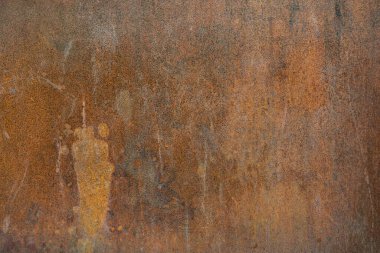 Eski paslı metal yüzey, siyah boya pul pul dökülüyor ve çatlıyor.