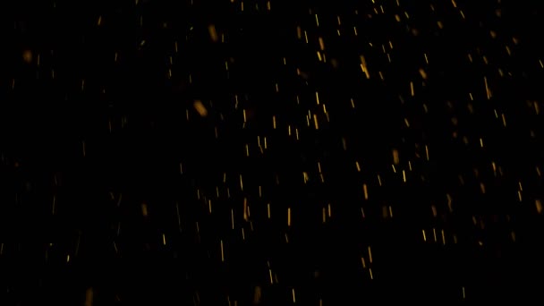 Les étincelles dorées du feu tombent comme une pluie dorée 