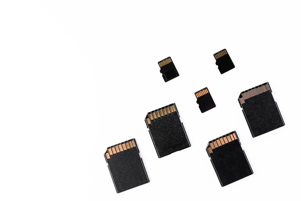 four sd cards and three micro sd scattered isolated in white background