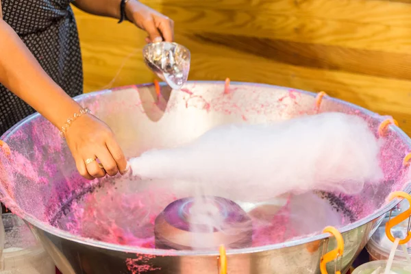 Girl making cotton candy at a fair — Stock Photo, Image