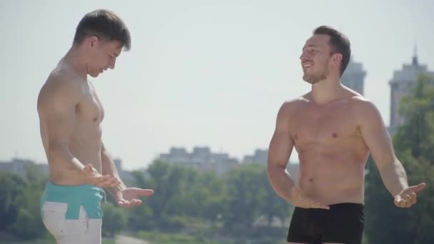 Les sportifs s'amusent dehors. Des hommes qui se montrent des muscles. Des gens sportifs avec des corps chauds se reposant à l'extérieur. Concept vantard. Beau paysage — Video