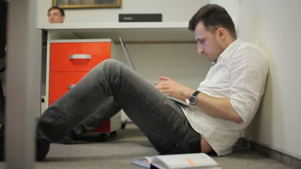 Guy Sitting Floor Office Table Man Keeps Laptop His Hands — Stock Video