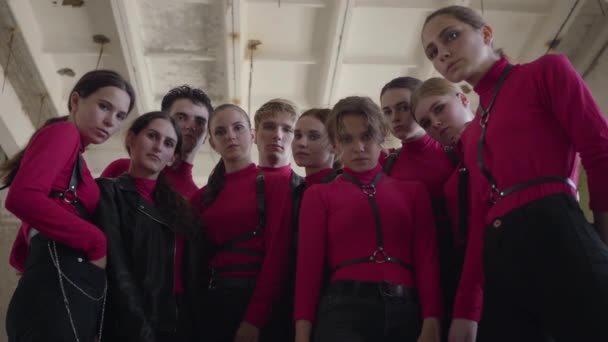 A crowd of young girls and guys in same stage costumes emotionally showing part of performance with hands for the shooting of the video — Stock Video