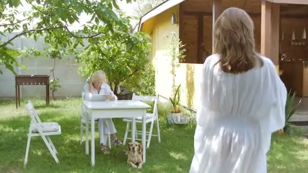 Daughter Gives Example Sunglasses Her Mother Elderly Woman Sitting Tablet — ストック動画