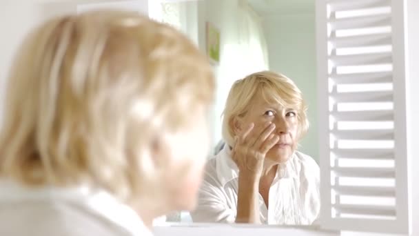 Пожилая Женщина Нанесла Крем Лицо Женщина Снимает Очки Женщина Стоящая — стоковое видео