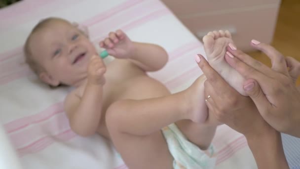 Mom Makes Massage Legs Her Baby Woman Holds Baby Foot — Stock Video