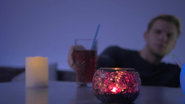Close Camera Focuses Candles Foreground Blurred Background Young Man Puts — Stok video