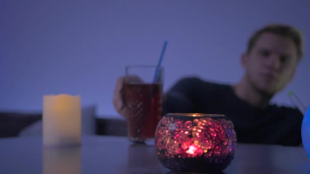 Close Camera Focuses Candles Foreground Blurred Background Young Man Puts — 图库视频影像