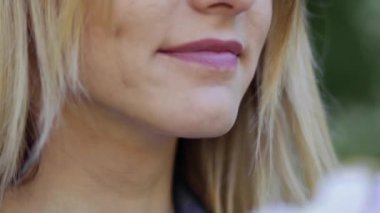 Elinde şakayık olan genç bir kadının portresi. Güzel bir kadın çiçek buketinden hoşlanır..