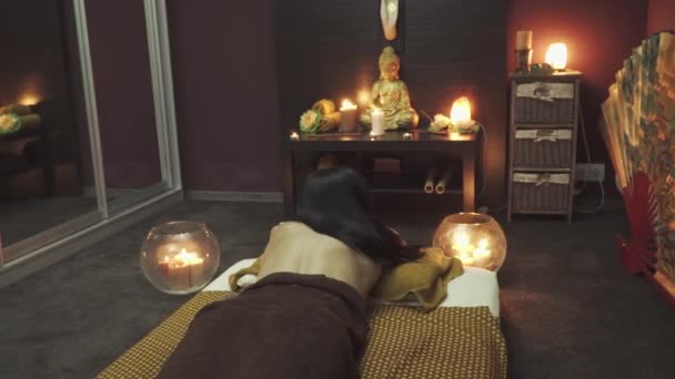 Sweet Girl Lies Massage Bed Candles Burning Bed Table Buddha — Stockvideo