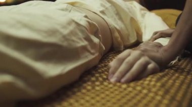 Taylandlı masör masaj salonunda el ve kol masajı yapıyor. Genç adam harika bir Tayland masajı yaptırıyor. Yakın plan..