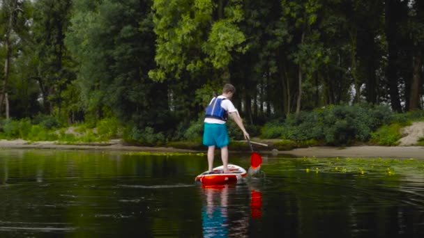 Guy Stands Life Jacket Kayak Floats Shore — Stock Video