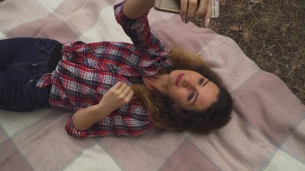 Jovem Mulher Está Fazendo Selfie Deitado Cobertor Floresta Vídeo — Vídeo de Stock