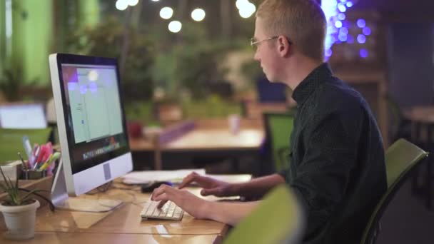 Young Man Glasses Sitting Workplace Table Computer Video Man Typing — Stock Video