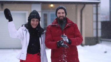 Genç pozitif çiftin kar altında arka bahçede dikilirken videosu. 