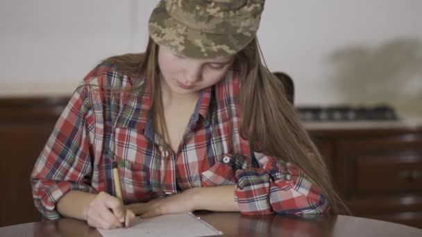 Very Young Girl Sit Home Table Writing Letter Soldiers Green — Stock Video