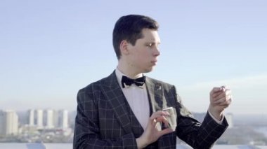 Genç profesyonel sihirbaz elinde tenis topuyla sihirbazlık yapıyor.