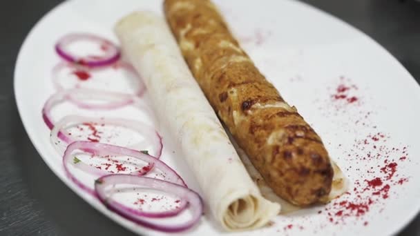 Tasty Kebab Sprinkling Paprika Big Plate Violet Onion Pita Close — Stockvideo