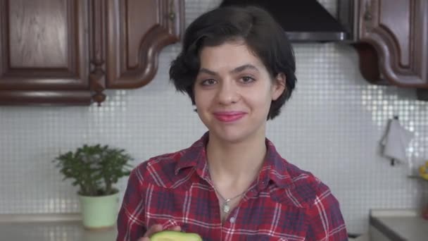 Portrait Laughing Smiling Girl Putting Front Eyes Green Fresh Avocado — Stockvideo