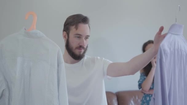 Video Handsome Bearded Man Asking Wife Advice Shirts Preparing Clothes — Stock Video