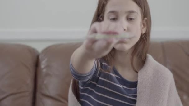 Tired Sick Girl Sitting Sofa Showing Thermometer Camera Video — Wideo stockowe