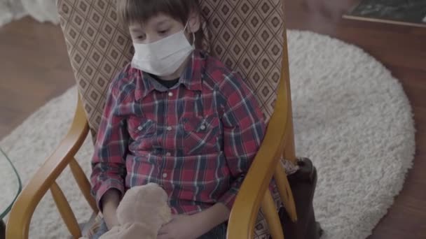 Video Little Ill Boy Sitting Armchair Medical Mask Face Holding — Stock Video