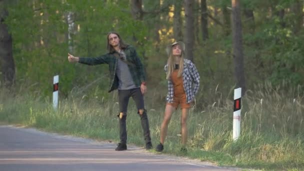 Trött Turist Par Rutig Hipster Skjortor Liftar Bilen Nära Skogen — Stockvideo