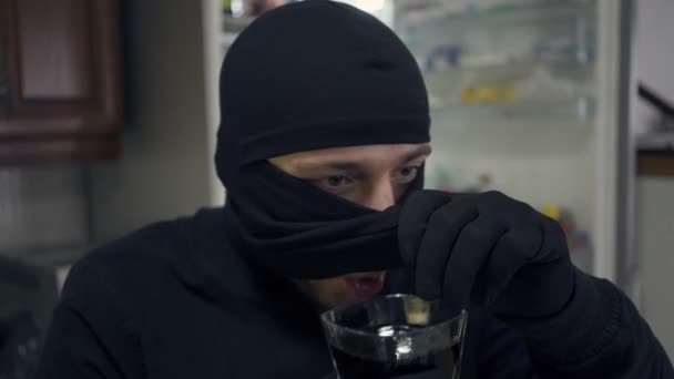 Close Young Caucasian Thief Black Clothes Raising His Balaclava Drinking — Stock Video