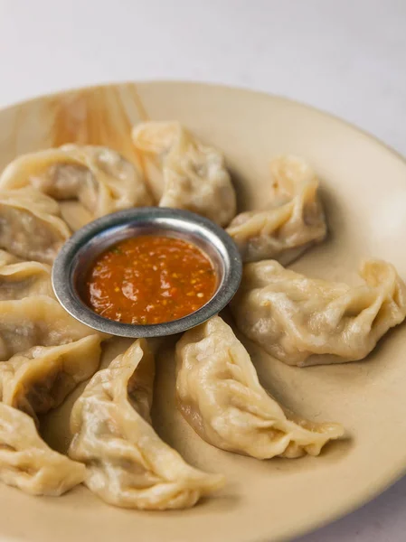 Traditional Nepalese food calls momos. Steamed cooked momos with sauce.