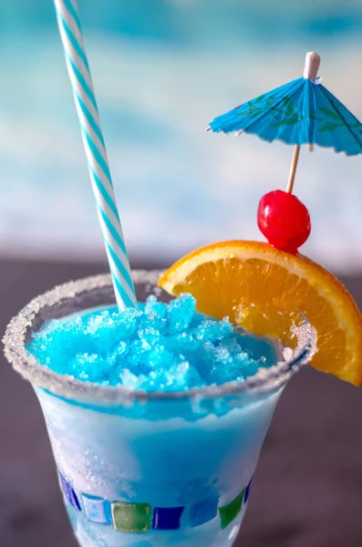 close up of a delicious frozen drink called a blue whale, with ice, lemonade, citrus vodka and curacao blue