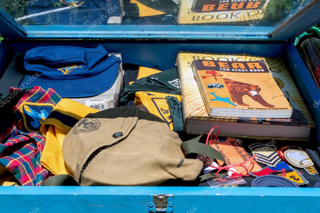 June 2018 St Joseph MI USA, antiques on the bluff event; a box of rare old boy scout items are a treasure trove for a collector. scouting uniform, badges, books and caps, beautifully preserved.