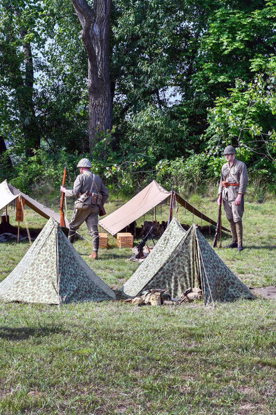 June 22 2018 st Joseph MI USA; lest we forget event is a  history reenactment about the korean war . Here, korean soldiers in vintage uniforms wait outside of small tents for a battle to begin