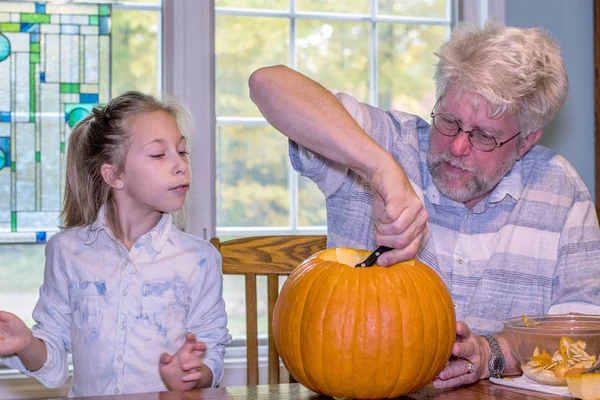 Young Girl Watches Grandpa Carves Pumpkin Halloween Fun — Stock Photo, Image