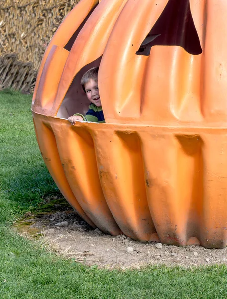 Little Boy Peeks Out Giant Pumpkin House — Stock Photo, Image