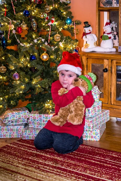 Boy hugging teddy bear Christmas morning — Stock Photo, Image