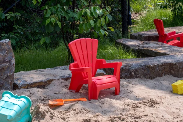 Chair and sand toys in sand box — Stock Photo, Image