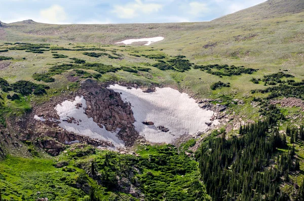 Snow filled basin in the mountains, in July