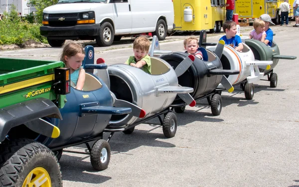 Kids in toy airplane ride — Stock Photo, Image