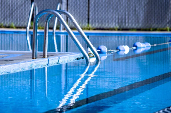 Ladder into a in ground pool — Stock Photo, Image