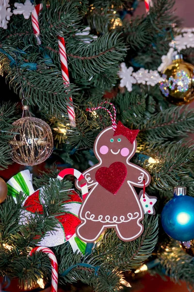 Sweet gingerbread woman decoration on a Christmas tree — Stock Photo, Image