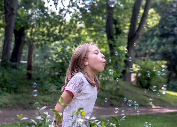 Νεαρή κοπέλα φυσάει φυσαλίδες — Φωτογραφία Αρχείου