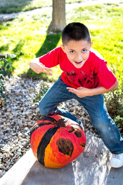 Boy proudly shows off his Halloween pumpkin — 스톡 사진