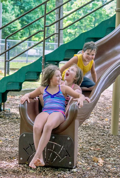 Young Children Pile Playground Slide Fun Candid Photo — Stock Photo, Image