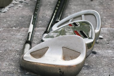 Three used golf clubs- wedges clipart