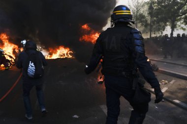 İtfaiyeciler Paris'te Emmanuel Macron politikasına karşı Sarı yelek hareketi tarafından çağrılan bir gösteri sırasında bir sokakta yanan scooter üzerine su püskürtmek, Fransa Nisan'da 20, 2019
